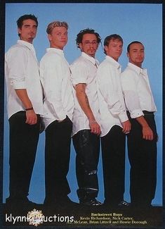 a group of men standing next to each other in front of a blue background wearing white shirts and black pants