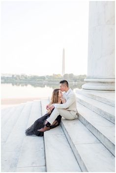 an engaged couple sitting on the steps of the lincoln memorial