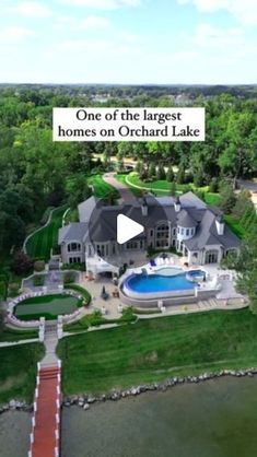 an aerial view of a large home on the water