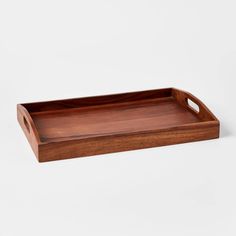 a wooden tray with handles on a white background