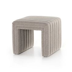 an upholstered stool with four rows of ribbeds on the top and bottom