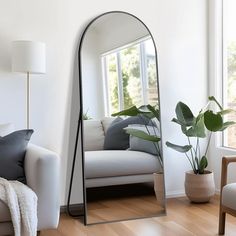 a living room filled with furniture and a large mirror on the wall next to a couch