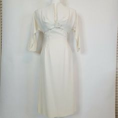 A stunning Young Modes by Claudia Young vintage sheath dress. Ivory colored with beading at bust and matching bolero jacket. No size label. Measures 43" long from shoulder to hem, 16" across the bust and 12" across the waist. Jacket 12" long 18" across the bust. Pre-owned vintage condition. No major flaws. Light soiling in areas. One area on side of dress where seam is that looks like it has glue on it. Would make the perfect wedding dress! Vintage White Fitted Dress For Formal Occasions, Formal Fitted Vintage White Dress, Vintage White Fitted Formal Dresses, Classic Fitted Dresses For Church, Vintage Fitted Dresses For Church, Elegant Vintage Cream Dress With Fitted Bodice, Elegant Cream Vintage Dress With Fitted Bodice, Vintage White Vintage Style Formal Dress, White Classic Vintage Dress For Formal Occasions