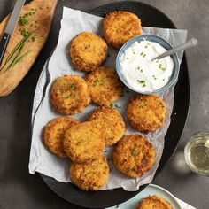 some fried food is on a plate with sour cream