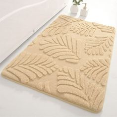 a bathroom rug with leaves on it