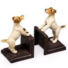 two small figurines of dogs playing with each other on black bases, one standing up and the other sitting down