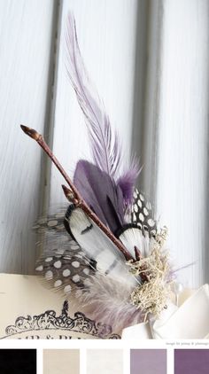 the color scheme is purple, black and white with some feathers on top of it