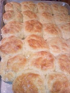 a baking pan filled with bread rolls on top of a counter