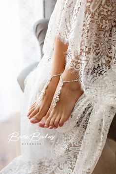 a woman in white dress sitting on a chair with her feet up and barefoot barefoot