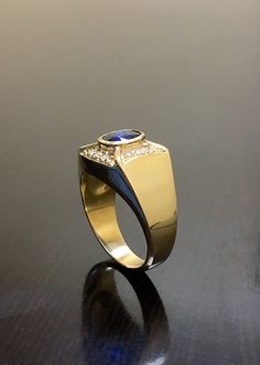 DeKara Designs Classic PICTURES DO NO JUSTICE ON THIS RING! This Ring Has Exceptional Quality From Design To the Sapphires, Diamonds and Gold. Metal- 18K Yellow Gold, .750, Stones- 1 Oval Ceylon Blue Sapphire 1.20 Carats. 12 Round Diamonds G-H Color VS2 Clarity 0.25 Carats. Art Deco Inspired 18K Yellow Gold Blue Sapphire Diamond Engagement Ring. This ring features two beautifully colored fiery Ceylon Blue Sapphire that is oval in shape and bezel set professionally. The sapphire is surrounded by Formal Blue Signet Ring Stamped 14k, Luxury Sapphire Diamond Ring With Polished Finish, Luxury 14k Gold Sapphire Ring With Diamond Cut, Luxury Polished Sapphire Ring Round Cut, Luxury Polished Round Cut Sapphire Ring, Luxury Polished Sapphire Ring With Round Cut, Classic Sapphire Signet Ring With Polished Finish, Luxury 14k Gold Brilliant Cut Sapphire Ring, Elegant Sapphire Signet Ring With Polished Finish