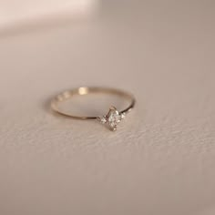 a diamond ring sitting on top of a table