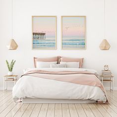 a bed room with a neatly made bed and two pictures on the wall above it