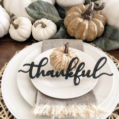 a white plate topped with a pumpkin sitting on top of a table