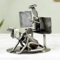 a metal figurine sitting on top of a table