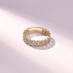 a gold ring with small diamonds on it