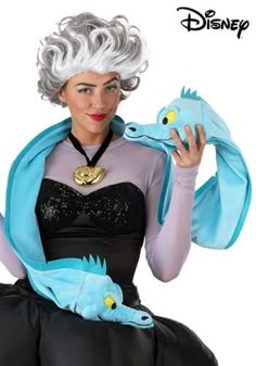 a woman dressed in an evil queen costume holding a stuffed animal and posing for the camera