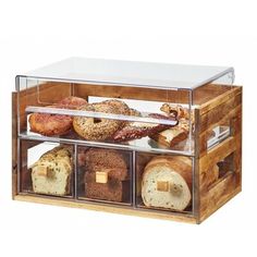 an assortment of breads and pastries in a display case on a white background