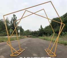 two yellow metal structures sitting in the middle of an empty road