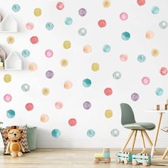 a child's room with polka dot wall decals on the walls and a teddy bear