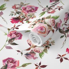 a floral wallpaper with pink roses and leaves on white background, as well as a roll of paper