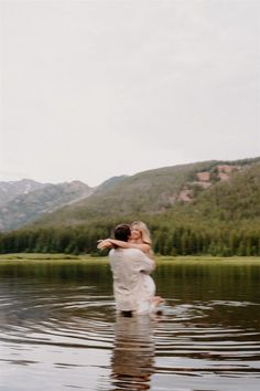 a man and woman are hugging in the water