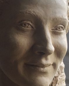 a close up of a statue of a woman's face