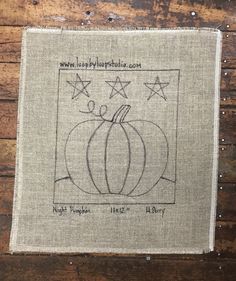 a small piece of cloth with a pumpkin on it and stars in the sky above