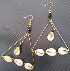 The earrings are  made with a lot of love and care from cowries and brass.   The wire is coiled to give a stunning look.  The are  beautifully designed for you, sister, mother, relative or a friend. The are light in weight and comfortable to wear. **This listing is for one pair of earrings.** Buy multiple items pay shipping for one the rest ships free. Custom orders are welcome. For more earrings, follow the link. https://www.etsy.com/listing/697317594/african-earrings-gift-for-her-earrings?ref=related-1 **Happy shopping** Dhl shipping express Thank you. Cowrie Shell Jewelry, Wire Jewelry Earrings, African Earrings, Women Earrings, Shell Jewelry, Cowrie Shell, The Wire, Jewelry Women, Gift Jewelry