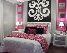 a bed room with a neatly made bed and pink accents