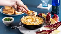 a person dipping some food into a skillet