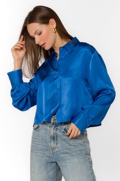 The Lilith Blouse features a long-sleeved, cropped design with a button-up front. The pleated back detail adds a touch of sophistication to this must-have piece. This silky blouse will elevate any outfit with its versatile style and flattering fit. Material: 100% Viscose Machine wash cold, hang dry Color: Lapis Blue Model is 5'9" and wearing a size S Imported Color Outfits, Lapis Blue, Silky Blouse, New Tops, Blue Blouse, Jacket Sale, Versatile Style, Jacket Outfits, Sweater Jacket