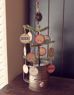 a christmas tree made out of wine corks in a metal bucket on top of a wooden table