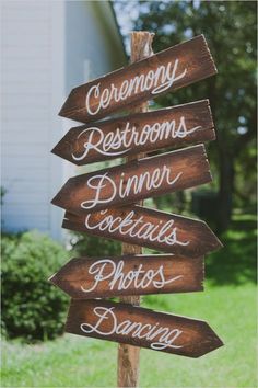 a wooden sign that says ceremony, restrooms, dinner, photos and dancing on it