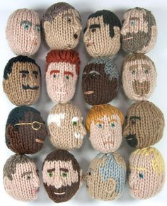 knitted faces are arranged in rows on a white surface, each with different facial expressions