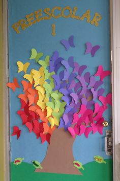 a door decorated with colorful paper butterflies and the word preschool written on it's side