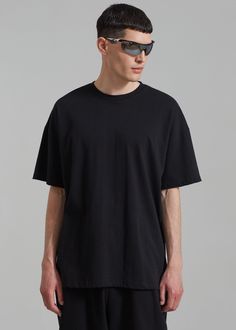 Color: Black Midweight t-shirt Boxy fit Crew neckline Drop shoulders Straight hem Unlined 100% Cotton Machine Wash Cold By The Frankie Shop. Imported Boxy Tee, Wearing Black, Drop Shoulder, Male Model, Black Tee, T Shirt, How To Wear, Black