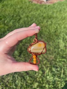 Beautiful banded agate mushroom with carnelian accents. This piece is calling to be claimed and find its forever home🫶🏻 Agate Amulet For Healing, Unique Orange Agate Necklace, Orange Amulet Pendant Jewelry, Spiritual Tumbled Agate Jewelry, Adjustable Carnelian Orange Jewelry, Agate Pendant For Meditation, Handmade Jasper Jewelry For Meditation, Hand Wrapped Agate Jewelry Gift, Hand Wrapped Agate Jewelry For Gifts