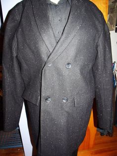 This is a very sharp Calvin Klein Peacoat. It looks new. Two inside pockets that button. The lining is 100% Polyester. There are two outer pockets. It is double breasted, with two buttons on each side. It is black with speckled beads of color sewn in.  Shoulder: 19" Pit: 23" Length: 36" Sleeve: 20" Fitted Tweed Wool Coat With Long Sleeves, Fitted Tweed Pea Coat For Winter, Fitted Tweed Pea Coat For Fall, Fitted Tweed Wool Coat, Semi-formal Fitted Double-breasted Wool Coat, Fitted Tweed Blazer With Double-breasted Button Fastening, Fitted Tweed Blazer With Double-breasted Button, Formal Fitted Tweed Wool Coat, Winter Fitted Tweed Jacket With Double-breasted Buttons