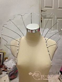 a mannequin with an elaborate head piece on it