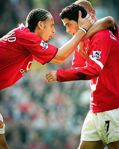 two soccer players are hugging each other on the field