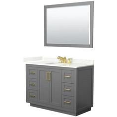 a white sink sitting under a mirror next to a gray vanity with gold handles and drawers