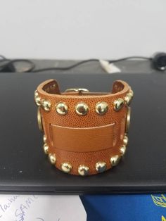 "This is a handmade genuine leather watchband. it is a classic style watchband. the cuff has a border of round studs. The has a sturdy buckle for fastening and adjusting the size. Adjustable from 7-1/4\" to 8-3/4\" Please message me for other colors and stud patterns or sizes." Punk Style Leather Jewelry With Wrist Strap, Punk Leather Jewelry With Wrist Strap, Punk Leather Wrist Strap Jewelry, Punk Leather Jewelry With Rivets, Leather Cuff Bracelet With Strap For Festival, Punk Style Studded Leather Bracelet, Punk Leather Bracelet With Studs, Punk Leather Cuff Wristband, Punk Style Brown Leather Jewelry