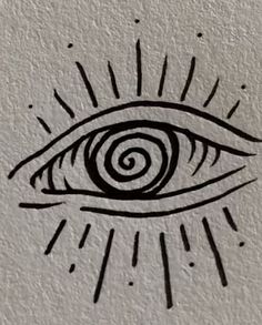 an eye drawn on the side of a wall with sun rays coming out of it