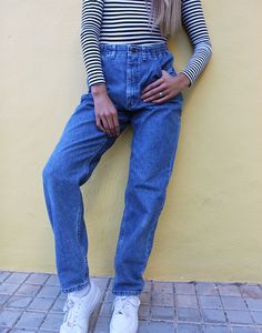 Vintage Lee jeans in blue denim. High rise. Zipper fly. Front pockets. Tapered leg style. Partial elasticated waist. UK 8-10 / Eur 36-38 Actual measurements - 27"(69cm) waist - 40"(102cm) hips - 31"(79cm) inner leg - 13"(34cm) rise. Material - Denim Condition - Excellent. Handpicked, repaired and ready to wear. This is an original vintage item, not new and minor signs of wear & age are expected, we will highlight any major flaws. Model is a UK 6/8 and is 5'7" tall Lee Jeans, Tapered Legs, Blue Denim, Ready To Wear, High Rise, Zipper, The Originals, Trending Outfits, How To Wear