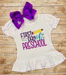 "Our My First Day of Preschool Ruffled Shirt Set is perfect for your little smarty! This adorable creation starts with a soft, quality, Laughing Giraffe Brand Ruffled Top that is adorned with non-shedding, glitter vinyl. The listing allows you to also add on the cute, matching, purple bow. The bow measures between 7-8 inches and is placed on a large, alligator clip. PLEASE VISIT OUR SHOP AT: https://www.etsy.com/shop/CutieCouture4u2 to view our other listings including headband sets, ruffle diap Cute Fitted T-shirt For School, Cotton Tops For Playtime And Back To School, My First Day Of Preschool, 1st Day Of Preschool, Back School Outfits, Preschool First Day, First Day Of Preschool, Preschool Shirts, Preschool Girl