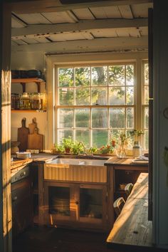 a kitchen with an open window, sink and wooden counter tops in front of it