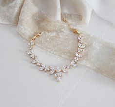 Add a touch of sparkle to your bridal look with this timelessly chic rose gold bridal bracelet! Handcrafted with marquise and round cut cz stones to create its lovely design. - Bracelet measures 6 inches and extends to 8.5 inches - Bracelet width measures 3/4 inch - Available in rose gold, rhodium, and yellow gold finishes - High quality Cubic Zirconia Matching jewelry: https://www.etsy.com/listing/687123210/rose-gold-bridal-necklace-and-earrings?ref=shop_home_active_19&frs=1&crt=1 Brows Gold Marquise Diamond Bracelet For Wedding, Gold Cubic Zirconia Tennis Bracelet For Wedding, Elegant Rose Gold Bracelets For Wedding, Elegant Marquise Bracelets For Wedding, Delicate Gold Tennis Bracelet For Wedding, Adjustable Rose Gold Tennis Bracelet For Wedding, Elegant Rose Gold Bracelet For Wedding, Marquise Cubic Zirconia Tennis Bracelet For Wedding, Adjustable Gold Bracelet With Cubic Zirconia For Wedding