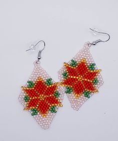 "\"Christmas Star\" - Beaded rhombus-shaped earrings (5 x 3.5 cm) Hand-beaded with small, glass beads. ~Hand made ~Unique design ~Hypoallergenic and nickel-free A perfect Christmas and New Year gift for your mother, wife, sister, daughter, or friend Each pair of earrings is individually made and has a unique design." Red Star-shaped Beaded Jewelry, Colorful Beads Christmas Earrings Gift, Colorful Beads Earrings For Christmas Gift, Christmas Gift Earrings With Colorful Beads, Handmade Jewelry For Christmas Celebration, Christmas Gift Jewelry With Faceted Beads, Handmade Jewelry For Holiday Celebration, Diamond-shaped Earrings With Ear Wire For Gifts, Gift Diamond-shaped Earrings With Ear Wire