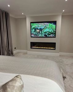 a bedroom with a bed, television and fireplace