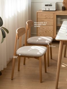 two wooden chairs sitting next to each other on top of a hard wood floored floor